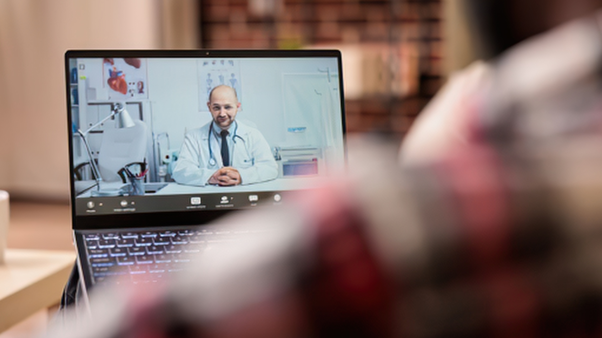 Doctor on a video consultation on a laptop screen